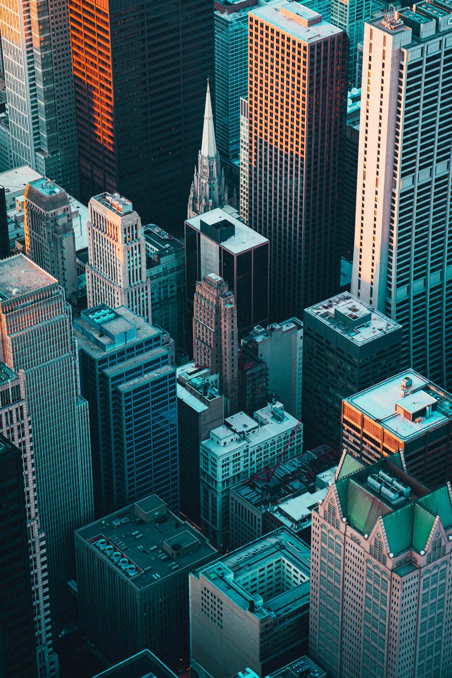 Aerial view of a dense city skyline at golden hour — skyscrapers evoking the growth of collective human knowledge
